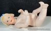 Vintage artist reproduction bisque porcelain and composite Piano Baby doll.